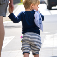 two year old baby with nice hair walking