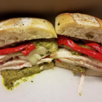 turkey sandwich with red peppers, cheese and pesto sauce