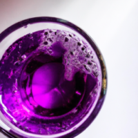 glass of bright purple fizzy drink