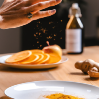 vertical smartphone-style photo of a wooden kitchen counter with simple home remedy ingredients arranged neatly, round white plate in foreground filled with fresh orange slices, a woman’s hand with neat polished nails sprinkling reddish powder over the slices mid-motion, powder particles visible in the air, behind the plate a bottle of apple cider vinegar, a small turmeric spice jar, and a baking soda box, casual kitchen setting, natural indoor lighting, soft shadows, realistic textures, health hack aesthetic, social media wellness post look, slight depth of field blur in background, photorealistic, warm tones --ar 9:16 --v 6 --style raw --quality 2