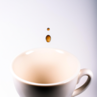 a cup of coffee that wonders curiosity with a drop going into the cup