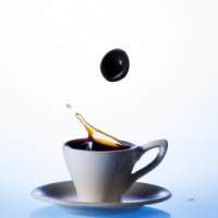 a cup of coffee that wonders curiosity with a drop going into the cup