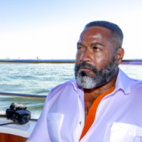 Black Male, 50s, with a beard, on a yacht