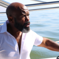 Black Male, 50s, with a beard, on a yacht