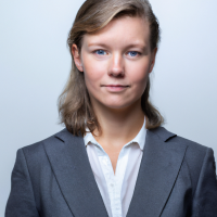 A square portrait professional picture of a 30 year old white female from head to chest dressed in a business suit.