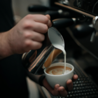 fresh cup of express being brewed by a barista